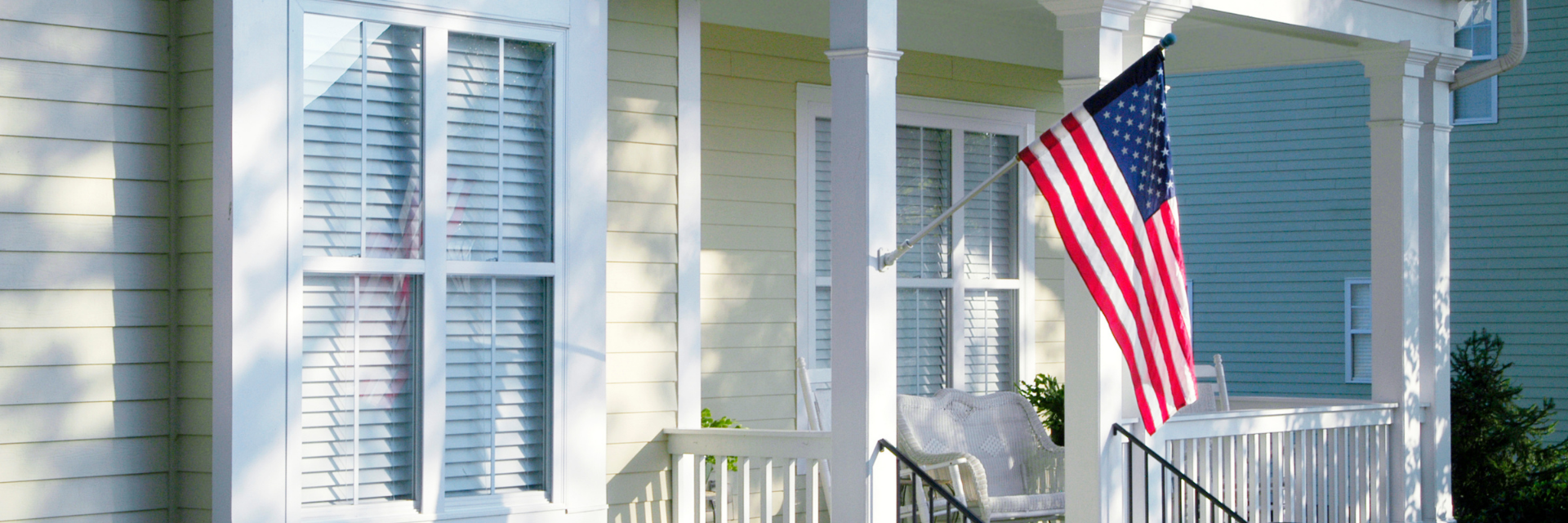 front porch of a house with an American flag