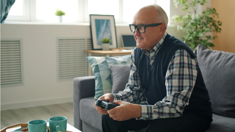 Elderly gentleman sitting on the couch inside his home
